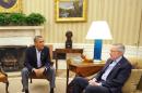 US President Barack Obama (L) sits next to Senate Majority Leader Harry Reid during a meeting with Senate Democratic leadership in the Oval Office of the White House on October 11, 2013 in Washington, DC