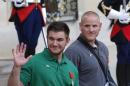 U.S. National Guardsman from Roseburg, Oregon, Alek Skarlatos , left, waves to the media as he leaves the Elysee Place in Paris, France, with U.S. Airman Spencer Stone, after being awarded with the French Legion of Honor by French President, Francois Hollande, Monday, Aug. 24, 2015. French President Francois Hollande and a bevy of officials are presenting the Americans with the prestigious Legion of Honor on Monday. The three American travelers say they relied on gut instinct and a close bond forged over years of friendship as they took down a heavily armed man on a passenger train speeding through Belgium. (AP Photo/Michel Euler)