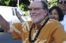 Hawaii Gov. Neil Abercrombie wears Google Glass as he waves at passing cars during a campaign event in Honolulu on Tuesday, Aug. 5, 2014. Abercrombie faces a tight re-election battle in a primary against state Sen. David Ige. (AP Photo/Oskar Garcia)