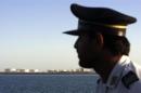 A member of security personnel looks on at oil docks at the port of Kalantari in the city of Chabahar