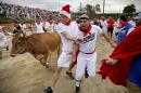 Participants run alongside charging bulls during the Great Bull Run at the Georgia International Horse Park, Saturday, Oct. 19, 2013, in Conyers, Ga. The event, expected to attract 3,000 runners Saturday, is inspired by the annual running of the bulls in Pamplona, Spain and has future stops planned in Texas, Florida, California, Illinois and Pennsylvania. (AP Photo/David Goldman)