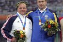 FILE - In this Aug. 20, 2004, file photo, silver medalist Adam Nelson, left, of the United States, and, gold medalist Yuriy Bilonog, of Ukraine, pose on the podium after the presentation ceremony in the men's shot put at the 2004 Olympic Games in the Olympic Stadium in Athens. IOC officials said Thursday, May 30, 2013, that Nelson has been bumped up to the gold medal after Bilonog was stripped of the gold medal in December because of doping. (AP Photos/David J. Phillip, File)