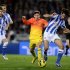 Barcelona's Lionel Messi tackles Real Sociedad's Carlos Martinez during their Spanish first division soccer match at Anoeta stadium in San Sebastian