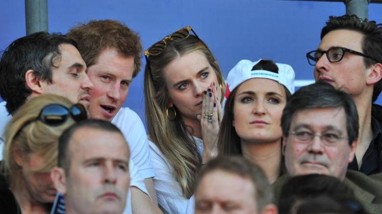 Prince Harry (2nd left) and socialite Cressida Bonas watch the Six Nations International rugby Union match between England and Wales at Twickenham, west London on March 9, 2014