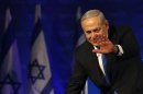 Israel's Prime Minister Benjamin Netanyahu waves to supporters upon arrival at the Likud party headquarters in Tel Aviv