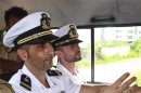 Italian sailors Latorre and Girone sit in a police vehicle after they appeared in court in Kochi