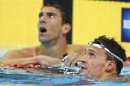 Lochte and Phelps check their times after swimming in their men's 200m individual medley during the U.S. Olympic swimming trials in Omaha