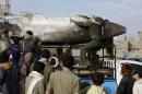Houthi rebels transport part of a Saudi fighter jet found in Bani Harith district north of Yemen's capital Sanaa