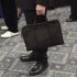 A man holds his briefcase at a job fair in New York