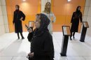 An Iranian woman talks on her phone while visiting an Islamic fashion exhibition in Tehran