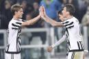 Juventus' Mario Mandzukic, right, celebrates with teammates after scoring during a Serie A soccer match between Juventus and Empoli, at the Juventus Stadium, Turin, Italy, Saturday, April 2, 2016. (Alessandro Di Marco/ANSA via AP) ITALY OUT