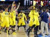 Michigan players including Tim Hardaway Jr., right, and Nik Stauskas (11) celebrate after defeating Syracuse in their NCAA Final Four tournament college basketball semifinal game on Saturday, April 6, 2013, in Atlanta. Michigan won 61-56. (AP Photo/Charlie Neibergall)