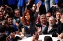 Former Argentine President Fernandez de Kirchner waves to supporters as she leaves a Justice building in Buenos Aires