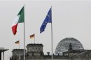 National flags of Italy and Germany and the EU flag are pictured in Berlin