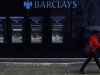 A man walks past a branch of Barclays bank in central London