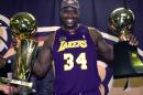 FILE - In this June 15, 2001, file photo, Los Angeles Lakers' Shaquille O'Neal holds up the MVP trophy, right, and the championship trophy after the Lakers won their second straight NBA championship, in Philadelphia. This year's Hall of Fame class includes a star-studded field of potential finalists, including Shaquille O'Neal, Yao Ming and Allen Iverson. That trio should be a lock to get in. (AP Photo/Mark J. Terrill, File)