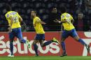 Estoril's Evandro Goebel, centre, celebrates with Bruno Lopes, both from Brazil, and Carlitos Garcia, right, after scoring a penalty goal against FC Porto in a Portuguese League soccer match at the Dragao stadium, in Porto, Portugal, Sunday, Feb. 23, 2014. Porto lost 1-0.(AP Photo/Paulo Duarte)
