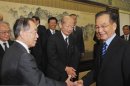 Japan's Ambassador to China Niwa shakes hands with China's Premier Wen after their meeting in Beijing