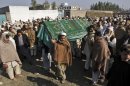 Pakistani relatives and mourners carry the body of aid worker Lubna Mahmoud, 26, who was killed on Tuesday, by gunmen, during her funeral procession in Swabi, Pakistan, Wednesday, Jan. 2, 2013. Gunmen on motorcycles sprayed a van carrying employees from a community center with bullets Tuesday, killing five female teachers and two aid workers, but sparing a child they took out of the vehicle before opening fire. (AP Photo/Mohammad Sajjad)