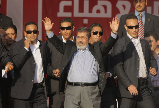 Egypt's President-elect Mohammed Morsi waves to his supporters at Tahrir Square, the focal point of Egyptian uprising, in Cairo, Egypt, Friday, June 29, 2012. In his first public speech addressing tens of thousands of mostly Islamist supporters, Morsi promised Saturday to work to free Omar Abdel-Rahman, the spiritual leader of men convicted in the 1993 World Trade Center bombing. (AP Photo/Amr Nabil)