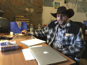 Ammon Bundy sits at a desk he's using at the Malheur …