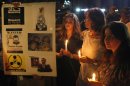 Lebanese and Syrian civilians take part in a vigil in front of the UN offices in Beirut on August 21, 2013