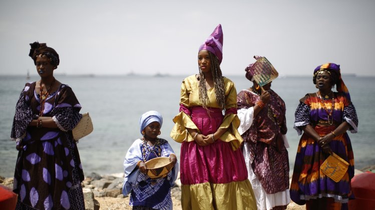 Senegalese women and children in traditional garb await the arrival of U.S. President Barack Obama and members of his family on Goree Island near Dakar