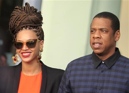 File of U.S. singer Beyonce and her husband rapper Jay-Z walk as they leave their Hotel in Havana