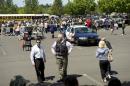 FILE - In this Tuesday, June 10, 2014, file photo, police direct parents to waiting students arriving by bus at a shopping center parking lot in Wood Village, Ore., after a shooting at Reynolds High School, in nearby Troutdale. Police in Washington state are asking the public to stop tweeting during shootings and manhunts to avoid accidentally telling the bad guys what officers are doing. Two recent incidents led the Washington State Patrol to organize the "TweetSmart" campaign: the search for a gunman in Canada after three officers were killed and the shooting at Reynolds High School. (AP Photo/Troy Wayrynen, File)