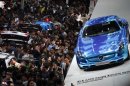 People looks at Mercedes-Benz cars during the the 15th Shanghai International Automobile Industry Exhibition in Shanghai