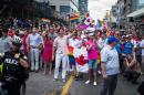 Canadian Prime Minister Justin Trudeau (middle, holding flag) participates at the annual Pride Festival parade, July 3, 2016 in Toronto, Ontario, Canada