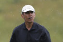 President Barack Obama prepares to tee off while golfing at Vineyard Golf Club in Edgartown, Mass., on the island of Martha's Vineyard Sunday, Aug. 18, 2013. (AP Photo/Steven Senne)