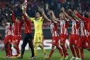 Olympiakos players celebrate their victory at the end of the Champions League Group A soccer match between Olympiakos and Malmo at Georgios Karaiskakis Stadium in the port of Piraeus near Athens, on Thursday, Dec. 9, 2014.(AP Photo/Petros Giannakouris)