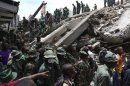 Rescuers search for survivors amongst the rubble of a collapsed building in the Kariakoo district of central Dar es Salaam