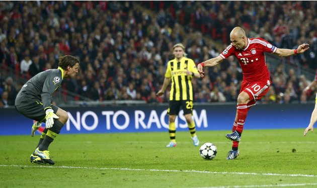 Bayern Munich's Mario Mandzukic scores past Borussia Dortmund's Marcel Schmelzer during their Champions League Final soccer match at Wembley Stadium in London