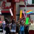 Gay rights groups and others protest and hold a "kiss-in" outside the Decatur, Ga., Chick-fil-A restaurant Friday, Aug. 3, 2012 as a public response to a company official who was quoted as supporting the traditional family unit. About two dozen protesters gathered on the busy corner to voice their views.   (AP Photo/David Tulis)