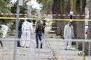 Tunisian forensics police inspect the scene of a suicide bomb attack in Tunis