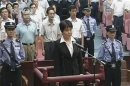 Gu Kailai, wife of ousted Chinese Communist Party Politburo member Bo Xilai, stands at the defendant's dock during a trial in the court room at Hefei Intermediate People's Court in this still image taken from video