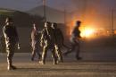 Afghan police arrive to secure the area after a car bomb detonated outside an ISAF civilian personnel compound in Kabul, Afghanistan, Friday, Oct 18, 2013. Police said the assault started at dusk when a car exploded near the gate of a compound, housing contractors from various countries, European diplomatic personnel and United Nations employees. (AP Photo/Anja Niedringhaus)