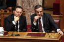 Greece's Prime Minister Samaras and Finance Minister Stournaras attend a parliament session before a vote for an omnibus reforms bill in Athens