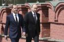 Russian President Putin and Prime Minister Medvedev walk to attend a wreath-laying ceremony at the Tomb of the Unknown Soldier in central Moscow