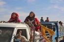 Syrians fleeing areas controlled by the Islamic State are seen as they come to safety in areas held by the Kurdish-Arab Syrian Democratic Forces alliance, on November 8, 2016, near the village of Ain Issa, north of Raqa, IS's de facto Syrian capital