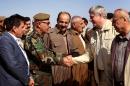 Canadian Prime Minister Stephen Harper (2nd right) greets Iraqi Kurdish Peshmerga forces during a visit on the frontline in Khazer, northern Iraq, on May 2, 2015