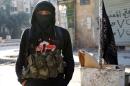 A member of jihadist group Al-Nusra Front stands in a street of the northern Syrian city of Aleppo on January 11, 2014