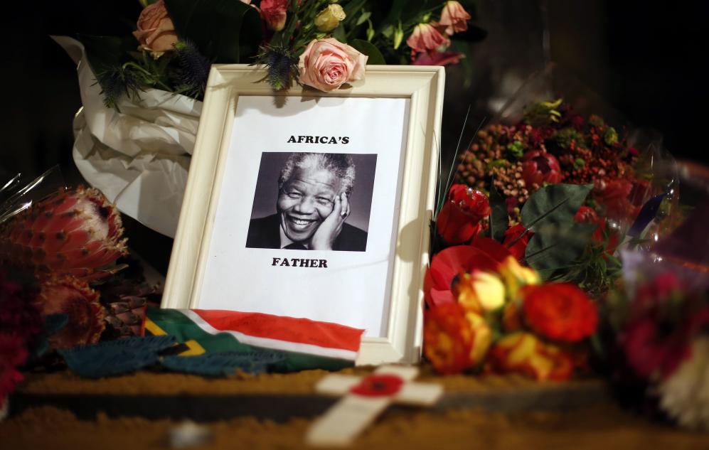 Flowers and tributes are left on the Nelson Mandela statue on Parliament Square in London