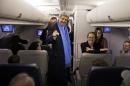 Secretary of State John Kerry talks with reporters before taking off for a flight to South Korea, Wednesday, Feb. 12, 2014, at Andrews Air Force Base, Md. Kerry is visiting South Korea, China, Indonesia, and the United Arab Emirates on a 7 day trip. (AP Photo/ Evan Vucci, Pool)