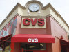FILE - A May 3, 2011 file photo,shows a customer exiting a CVS store in Providence, R.I.  CVS Caremark said Monday May2, 2012,  its first-quarter earnings rose 9 percent, as the drugstore operator and pharmacy benefits manager gained customers from an acquisition and a competitor's contract dispute.  (AP Photo/Steven Senne, file)