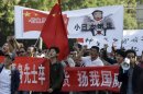 Chinese protesters march with banners declaring Diaoyu Islands, known as Senkaku in Japanese, belong to China near the Japanese Embassy in Beijing, China, Sunday, Sept. 16, 2012. (AP Photo/Ng Han Guan)