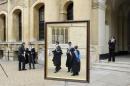 Graduates queue to have their photograph taken after a graduation ceremony at Oxford University in England