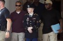 U.S. Army Pfc. Bradley Manning is escorted out of a courthouse at Fort Meade in Maryland